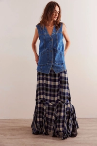 Detail of V-neck mid-blue denim vest with functional buttons and large front pockets