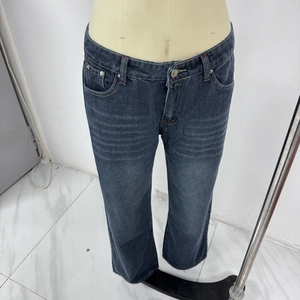 Detail of dark blue wide-leg jeans featuring red contrast stitching and rivets