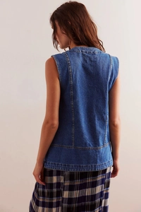 Detail view of the back of a blue washed denim vest featuring contrast stitching lines