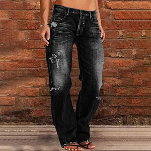 Detail view of distressed black denim jeans with washed finish and ripped knee style