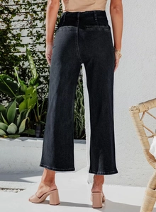 Rear view of high-waisted wide-leg black denim pants with elegant drape and fit