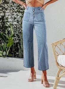 Detail of high waist light blue denim jeans with four vintage buttons and front patch pockets
