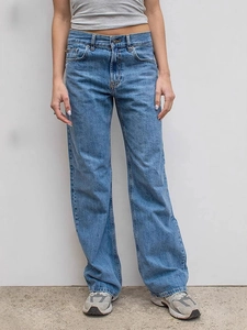 Women's high-waisted wide-leg denim jeans in washed blue with a retro vintage aesthetic