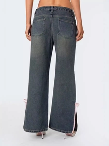 Deep grey flare jeans for women featuring side slits and decorative pink satin bows