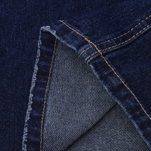 Detailed close-up of dark blue denim fabric texture with yellow double-row stitching