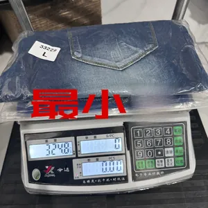 Macro shot of men's blue denim shorts in size L being weighed on a digital scale