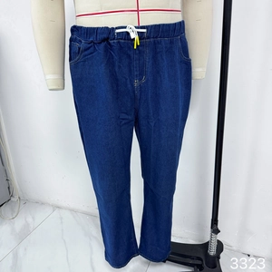 Macro detail of dark blue wide-leg denim pants featuring elastic drawstring waist and pockets