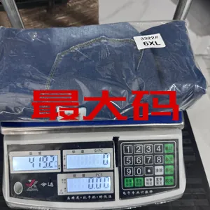 Detail view of 6XL stretch denim shorts being weighed showing product weight of 419 grams