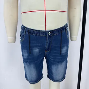 Detail of blue denim shorts featuring an elastic waistband with black drawstring and button