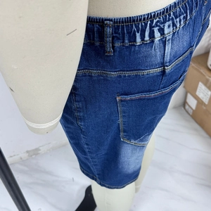Detail of elastic waist and contrast stitching on dark blue stretch denim shorts