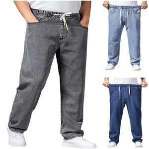 Detail of adjustable elastic drawstring waistband on men's wide-leg denim trousers