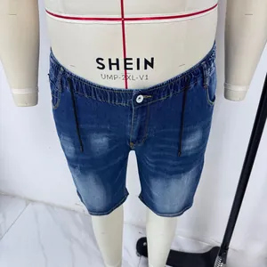 Macro detail of blue denim shorts showing elastic drawstring waist and vintage wash texture