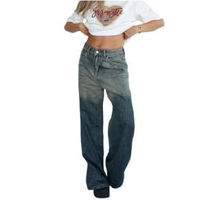 Detail of vintage low-rise wide-leg jeans with faded wash and cat-whisker texture