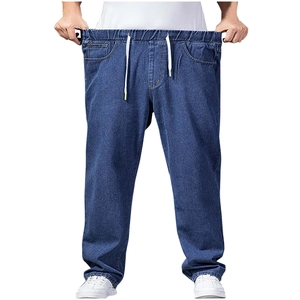 Detail view of deep blue denim jeans showing elastic waistband and drawstring stretch