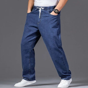 Detail of blue straight leg jeans featuring elastic waistband and white drawstrings