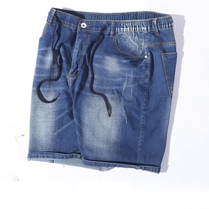Detail of elastic waist with navy drawstring and button on men's blue denim shorts