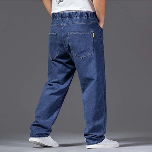 Detail of loose fit men's dark blue jeans featuring elastic waist and large back pockets