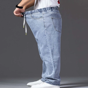 Detail showing elastic waist with white drawstring on light blue wide leg baggy jeans