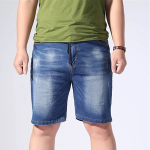 Detail view of men's blue denim shorts featuring washed texture and adjustable drawstring