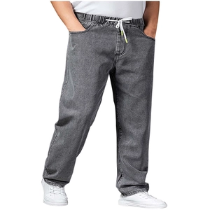 Detail of grey wide-leg denim pants featuring an elastic drawstring waist and side pockets