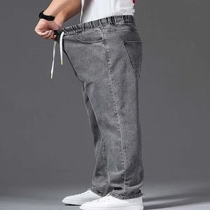 Detail of wide leg gray wash jeans showing the flexible elastic drawstring waistband
