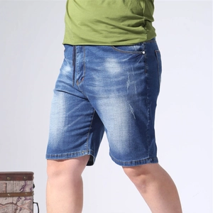 Detail of blue wash denim shorts featuring elastic drawstring waist and distressed texture