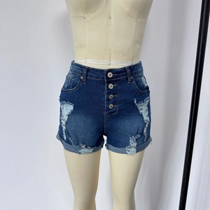 Close-up of high waist denim shorts featuring a four-button fly and distressed ripped details
