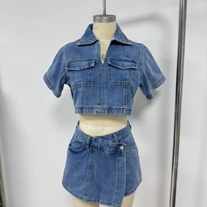 Detailed view of blue denim co-ord set with cargo pockets and asymmetric skirt design