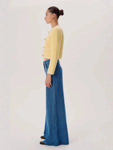Women high waisted wide leg jeans with yellow tweed jacket and gold buttons styling