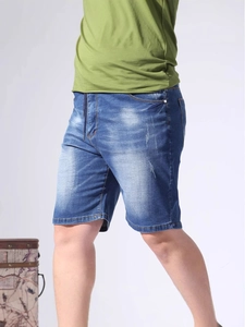 Men's stretchy denim shorts in washed blue with distressed details and elastic waist