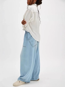 Women's light blue wide-leg denim jeans with elastic waist and large side pockets