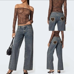 Nahaufnahme von Herz-Leoparden-Patch auf den Gesäßtaschen dieser blauen Jeans mit weitem Bein
