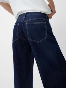 Jean vintage délavé pour femme à coupe large avec poches arrière et surpiqûres oranges