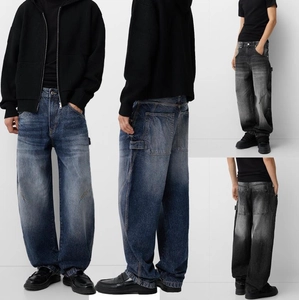 Detail view of baggy cargo jeans for men featuring large side pockets and washed finish