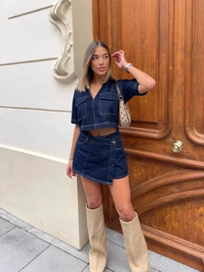 Women's dark blue denim two-piece cargo set with V-neck top and asymmetric mini skirt