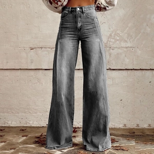 Detail of high waisted grey wide leg jeans featuring unique vertical seam stitching and denim texture