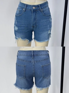 Macro shot showing front and back details of high waist ripped blue denim shorts