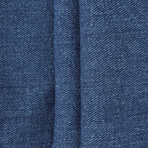Macro shot of dark blue denim fabric texture with twill weave and fiber details