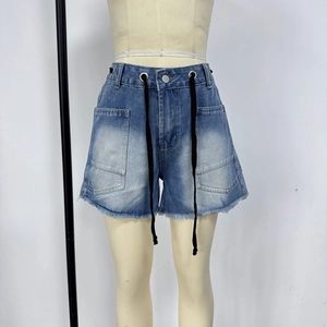 Detail of light blue denim shorts featuring large cargo pockets and a drawstring waist