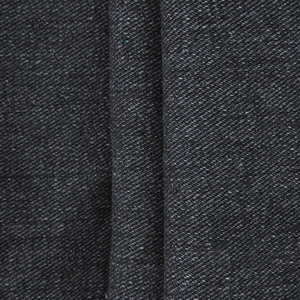 Macro detail of thick dark gray twill fabric texture on heavy-duty denim overalls for men