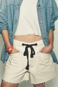 Detail of cargo denim shorts with eyelets, thick black drawstring and distressed hem
