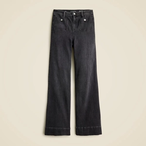 Detail shot of high-waisted wide-leg jeans in washed black with silver metal buckle pockets