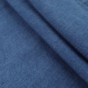 Close-up of premium blue denim fabric showing detailed twill weave and cotton texture