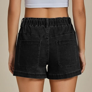 Detail view of the elastic waistband and large back pockets on black denim shorts