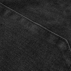 Detail shot of black denim fabric texture with fine stitching and twill weave patterns