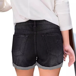 Women's vintage black denim shorts with ripped cuffs and back pocket detail