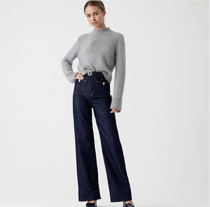 Detail of high-waist wide-leg denim jeans with a grey turtleneck sweater set