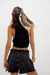 Back view of high-waisted black denim shorts with raw hem and sleeveless cropped vest