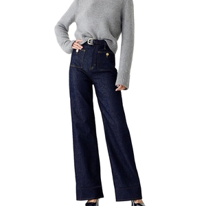Detail view of high-waisted dark blue wide-leg jeans with vintage gold buttons and front pockets