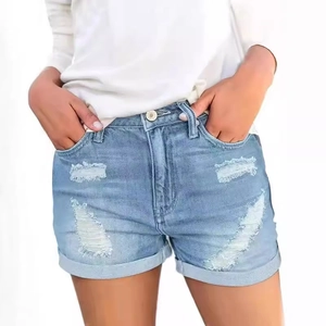 Women's light blue distressed denim shorts with ripped details and folded hem
